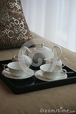 Tea pot on a bed Stock Photo