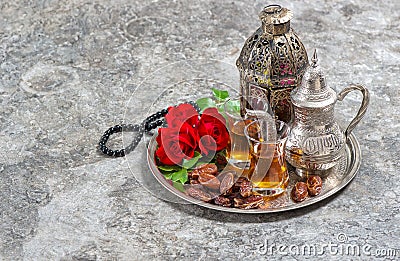 Tea and red rose flower, arabian lantern and rosary. Islamic holidays. Ramadan Stock Photo