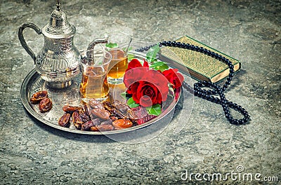 Tea and red rose flower, holy book quran and rosary. Ramadan kareem vintage Stock Photo