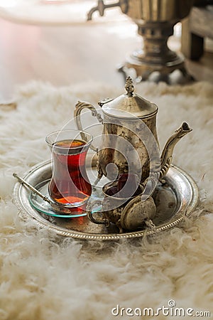 Tea set in oriental style in pear shaped glass with vintage kettle and dates fruit Stock Photo
