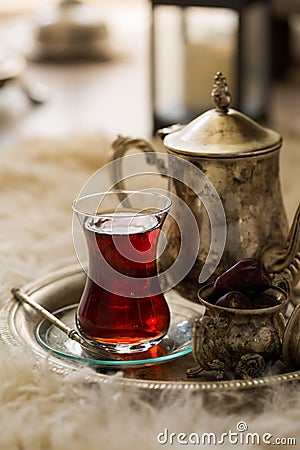 Tea set in oriental style in pear shaped glass with vintage kettle and dates fruit Stock Photo