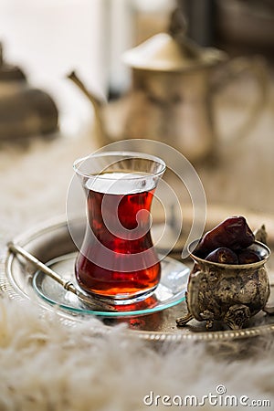 Tea set in oriental style in pear shaped glass with vintage kettle and dates fruit Stock Photo