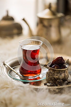 Tea set in oriental style in pear shaped glass with vintage kettle and dates fruit Stock Photo