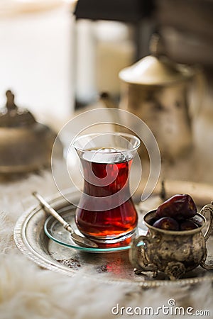 Tea set in oriental style in pear shaped glass with vintage kettle and dates fruit Stock Photo