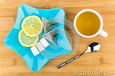 Tea, slices of lemon, lumpy sugar in blue plate Stock Photo