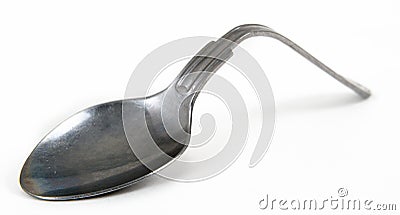 Tea spoon bent with willpower isolated on white Stock Photo