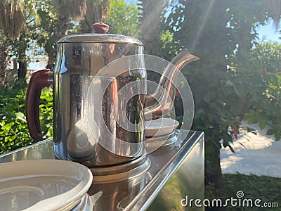 Tea table in the garden in summer time. Hygge style evening Stock Photo