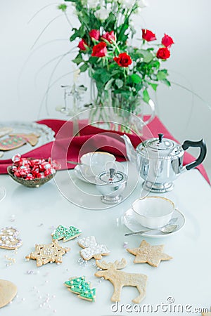 Tea table, porcelain tea cups, silver tea pot, home made cookies Stock Photo