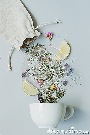 Tea time. Dry herbal tea and cup on the gray background, top view Stock Photo