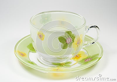 Tea transparent cup on a saucer with an ornament f Stock Photo