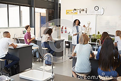 Teacher addressing pupils in a high school science lesson Stock Photo