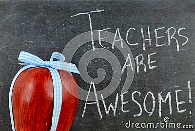 Teacher appreciation image of a red apple tied up with a cute blue ribbon Stock Photo