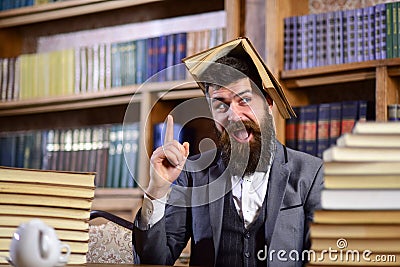 Teacher with beard with opened book on his head Stock Photo