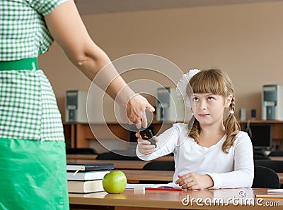Teacher is confiscating mobile phone at lesson Stock Photo