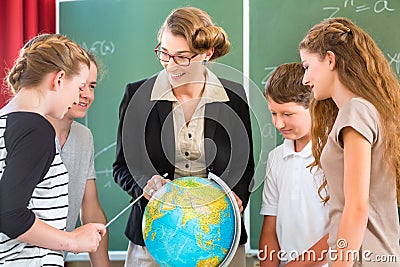 Teacher educate students having geography lessons in school Stock Photo