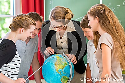 Teacher educate students having geography lessons in school Stock Photo