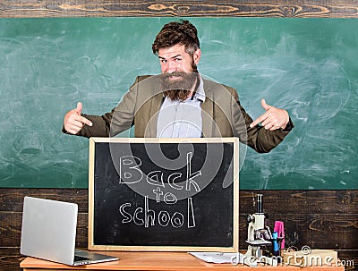 Teacher experienced educator welcomes new enrollees to begin study and get education. Welcome back to school. Teacher or Stock Photo