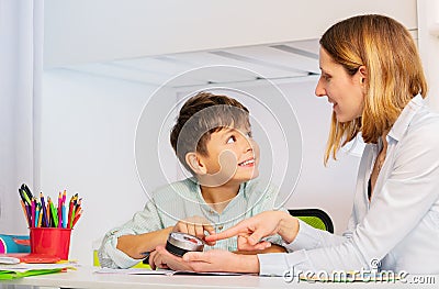 Teacher explain autistic boy lesson duration timer Stock Photo