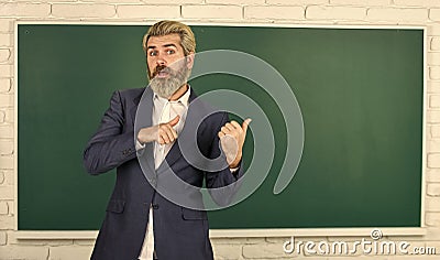 Teacher explain topic. Man teacher in front of chalkboard. Have good grade point average in high school. Teacher friend Stock Photo