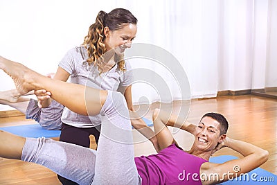 Teacher explaining woman fitness exercises Stock Photo