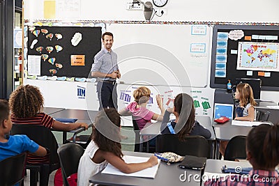 Teacher at front of class in an elementary school lesson Stock Photo