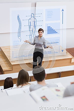 Teacher in front of futuristic interface asking a question Stock Photo