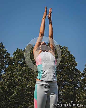 Teacher in front of almost 2000 people taking a free collective yoga class in a city park in Milan, Italy Editorial Stock Photo