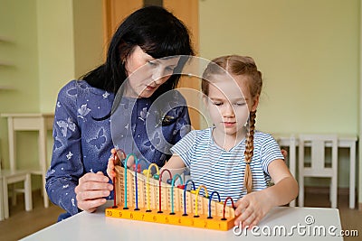 A teacher with girl learning to add and subtract Stock Photo