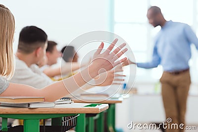 Teacher giving high five to multicultural group of high school Stock Photo