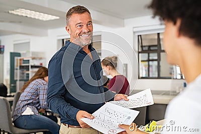 Teacher giving test result to college student Stock Photo