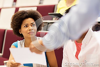 Teacher giving test to student girl on lecture Stock Photo