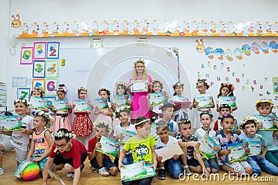 Teacher with a group of first graders children on the last day of school Editorial Stock Photo