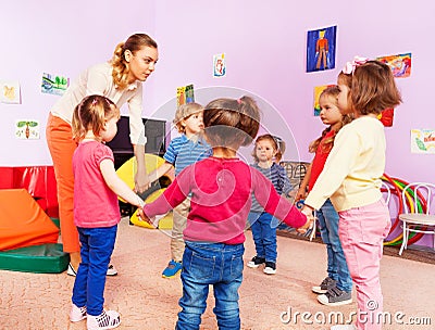 Teacher and group of kids in kindergarten Stock Photo