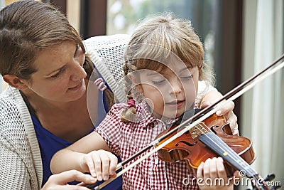 Teacher Helping Young Female Pupil In Violin Lesson Stock Photo