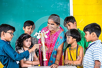 Teacher with human spine biological model explaining to students during anatomy class at school - conept of stem Stock Photo