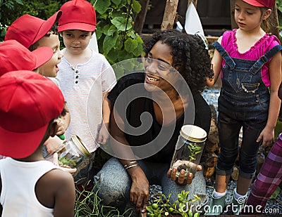 Teacher and kids having fun learning about plants Stock Photo