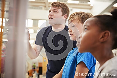 Teacher and kids looking at a science exhibit, close up Stock Photo