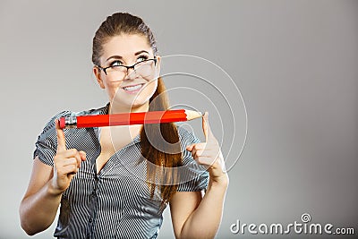 Teacher looking elegant woman holding big pencil Stock Photo