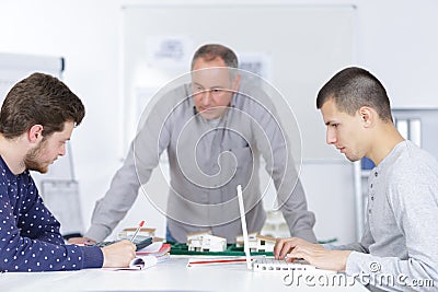 Teacher with male students clas Stock Photo