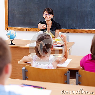 Teacher pointing at schoolgirl Stock Photo