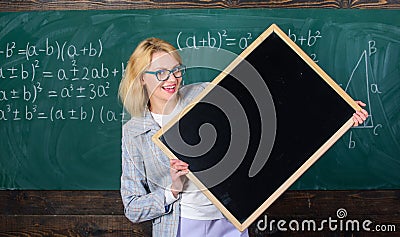 Teacher show school information. Remember this information. Teacher smart smiling woman hold blackboard blank Stock Photo