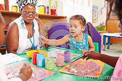 Teacher sitting with kids in a preschool class, close up Stock Photo