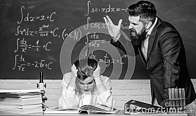 Teacher strict serious bearded man having conflict with student girl. Conflict situation. School conflict. Demanding Stock Photo