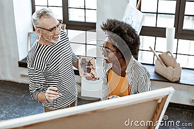 Teacher and student of art school feeling cheerful working together Stock Photo