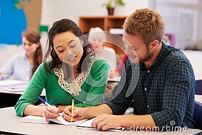 Teacher and student work together at adult education class Stock Photo