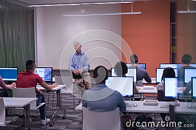 Teacher and students in computer lab classroom Stock Photo