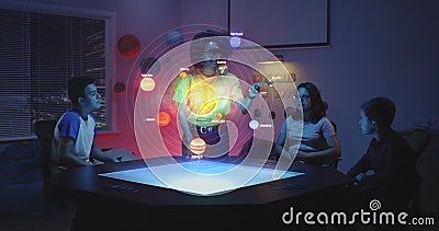 Teacher and students looking at solar system hologram Stock Photo