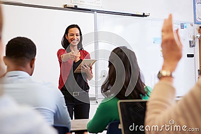 Teacher with tablet and students at an adult education class Stock Photo
