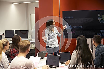 Teacher Talking To Students In College Class Stock Photo