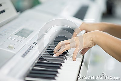 Teacher teach keyboard electone instument to a boy in the class room Stock Photo